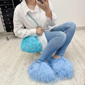 Cozy light blue Mongolian fur slides paired with matching textured shoulder bag
