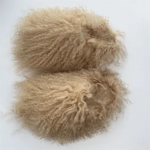 Detailed view of the curly Mongolian lamb fur texture on these warm beige slides