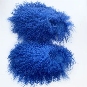 Macro view of premium bright blue curly Mongolian fur slides with long fluffy texture