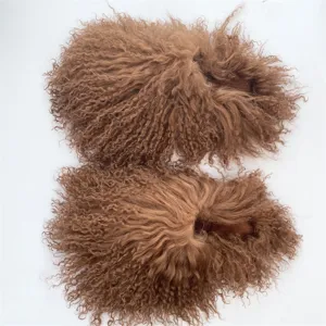 Detailed macro view of curly brown Mongolian sheep fur slides with soft fluffy texture