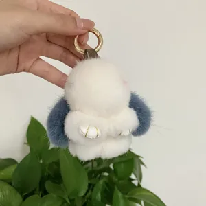 Detailed view of soft 8cm white mink fur rabbit keychain pendant with blue ears