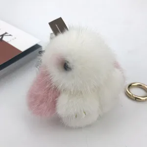 Macro view showing the soft texture of a white mink fur rabbit keychain accessory