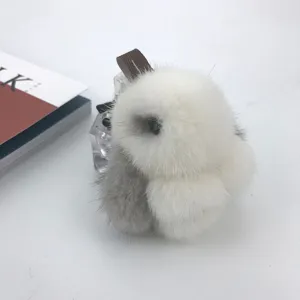 Detailed view of a soft white and grey mink fur bunny keychain with a leather strap