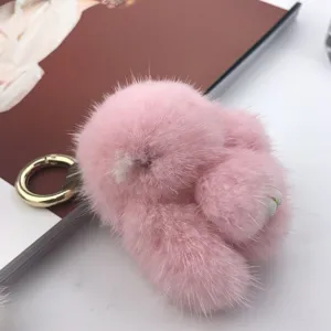 Close-up detail of a soft pink mink fur bunny keychain featuring a premium golden ring