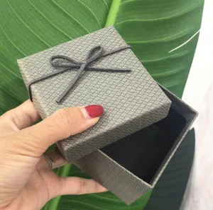 Textured grey gift box with decorative bow detail for plush rabbit pendant packaging