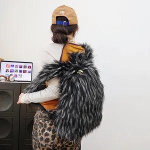 Detail view of Y2K style faux raccoon fur backpack showing the long shaggy texture in grey.