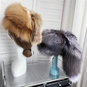 Close-up detail of thick ethnic fox fur hats with tails in red and silver fox colors