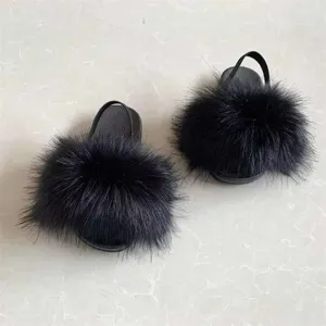 Top view detail of black plush faux fur kids' sandals with elastic back strap