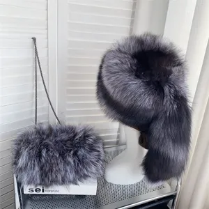 Detailed view of luxury silver fox fur hat with tail and matching plush chain bag