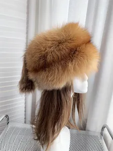 Detailed view of a thick red fox fur winter hat featuring a decorative dangling tail