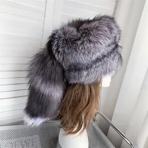 Detail view of thick silver fox fur hat with a long decorative tail for winter warmth.