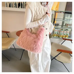 Lifestyle view of a soft pink faux fur tote bag worn as a crossbody by a model