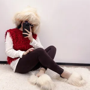 Detailed view of fluffy faux raccoon fur hat and matching slippers for a cozy winter outfit