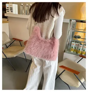 Stylish pink faux fox fur shoulder bag shown from the back in a cozy cafe background
