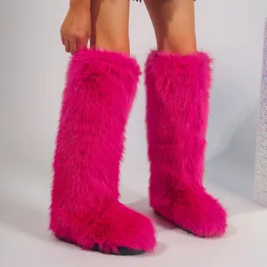 Close-up of vibrant pink Y2K style faux fur knee-high boots on model