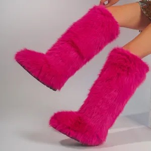 Vibrant hot pink faux fox fur knee-high boots in a trendy and bold Y2K fashion style.