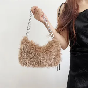 Detailed view of tan fuzzy faux fur baguette bag featuring a chunky silver chain strap