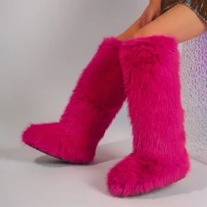 Vibrant pink faux fur knee-high snow boots featuring a trendy Y2K fashion aesthetic