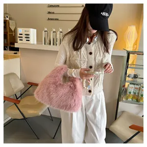 Model carrying a soft pink faux fox fur tote bag in a cozy cafe setting