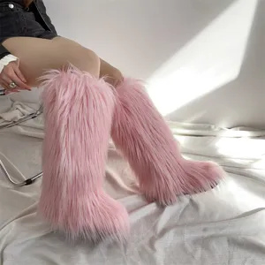 Close-up detail of pink faux fur knee-high boots showing fluffy texture and warm lining