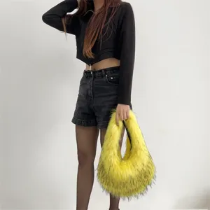 Detailed view of yellow faux fur plush handbag being carried by a model in Y2K style outfit