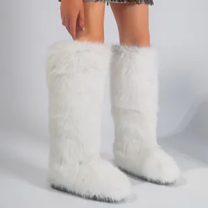 White faux fur knee-high snow boots with cozy lining in trendy Y2K style for women