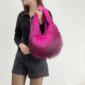 Close-up of pink and black faux raccoon fur handbag held by model for Y2K style