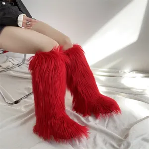Stylish vibrant red faux fur knee-high snow boots for women in a cozy winter fashion style