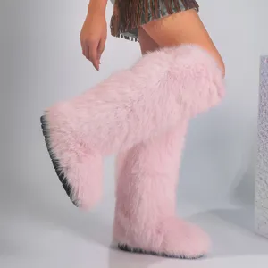Close-up of pink fluffy faux fur knee-high Y2K style snow boots