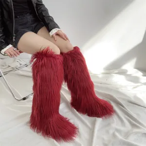 Detail view of stylish red faux fur knee-high snow boots for women in a cozy setting
