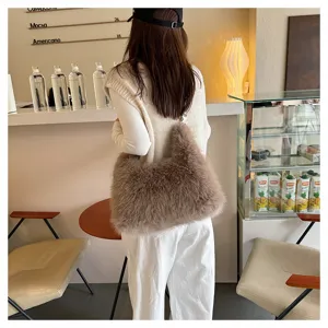 Detailed back view of a woman wearing a soft brown plush faux fox fur tote bag in a cafe