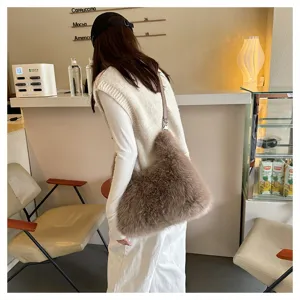 Detailed view of a stylish brown faux fur tote bag carried by a model in a cafe