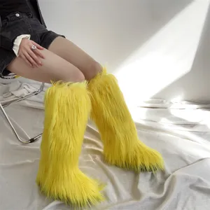 Stylish yellow faux fur knee-high snow boots for women in a minimalist indoor setting.