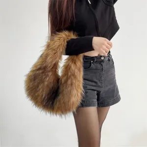 Detail view of a brown faux fur handbag in a trendy Y2K aesthetic worn by a model.