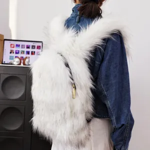 Detail of white faux fur backpack in Y2K style worn by a model in denim jacket