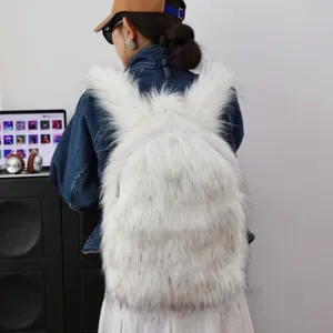 Detail view of a white fluffy faux raccoon fur backpack in Y2K style worn by a model.