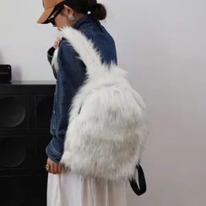 White faux raccoon fur backpack in Y2K fashion style worn by a model in studio setting