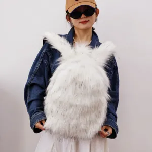 Detail view of a white faux fur backpack with rabbit ears worn by a model in denim jacket