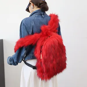 Back view of a model wearing a vibrant red faux raccoon fur backpack in Y2K style.