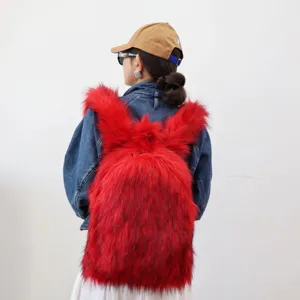 Detail of a bright red faux fur backpack in a Y2K style worn over a denim jacket.