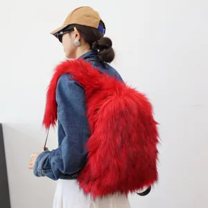 Detailed side view of a vibrant red faux raccoon fur backpack worn by a model in denim.