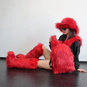Detail of red faux raccoon fur backpack with Y2K fashion accessories on model.