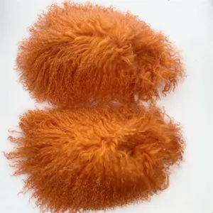 Vibrant orange Mongolian curly sheep fur slides with soft texture for winter warmth