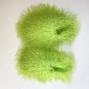 Detailed view of neon green Mongolian sheep fur slides with a curly texture