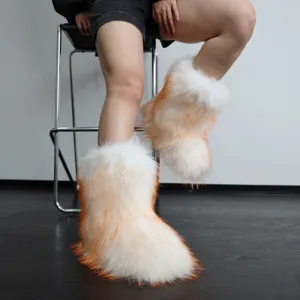 Close-up of white and orange faux fur snow boots on a model for autumn Y2K style