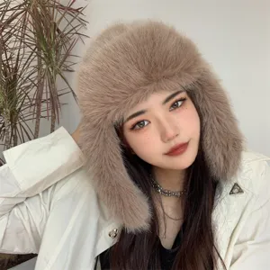 Detailed view of soft brown faux fox fur trapper hat worn by model for winter warmth