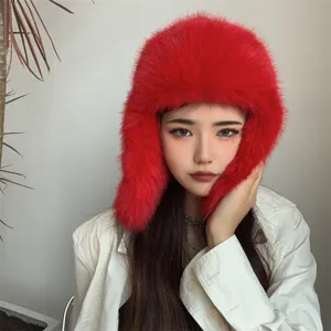Detailed texture of red faux fox fur trapper hat with earmuffs for winter