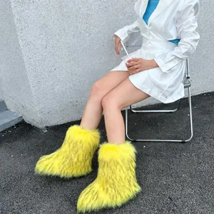 Model wearing bright yellow fluffy faux fur snow boots for a vibrant Y2K fashion style