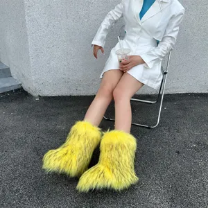 Close-up of fluffy yellow faux fur Y2K snow boots worn by a person sitting outdoors