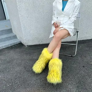 Detail shot of fluffy yellow faux fur boots on a model sitting outdoors in Y2K style